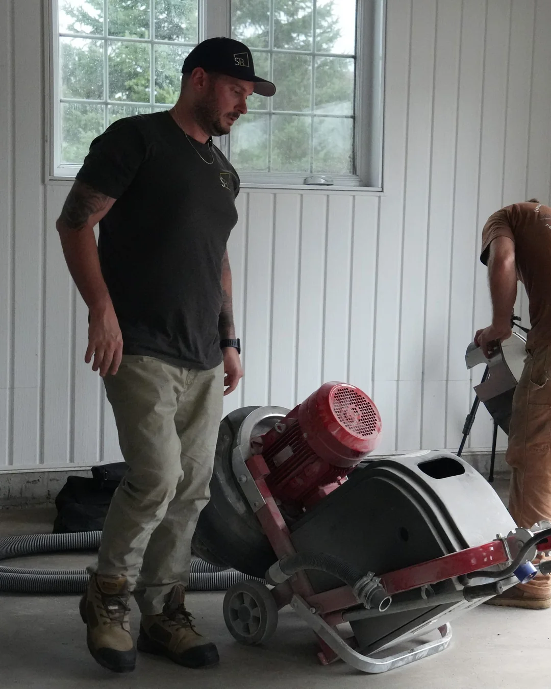 PO sur un chantier, avec un employé qui prépare une machine à plancher